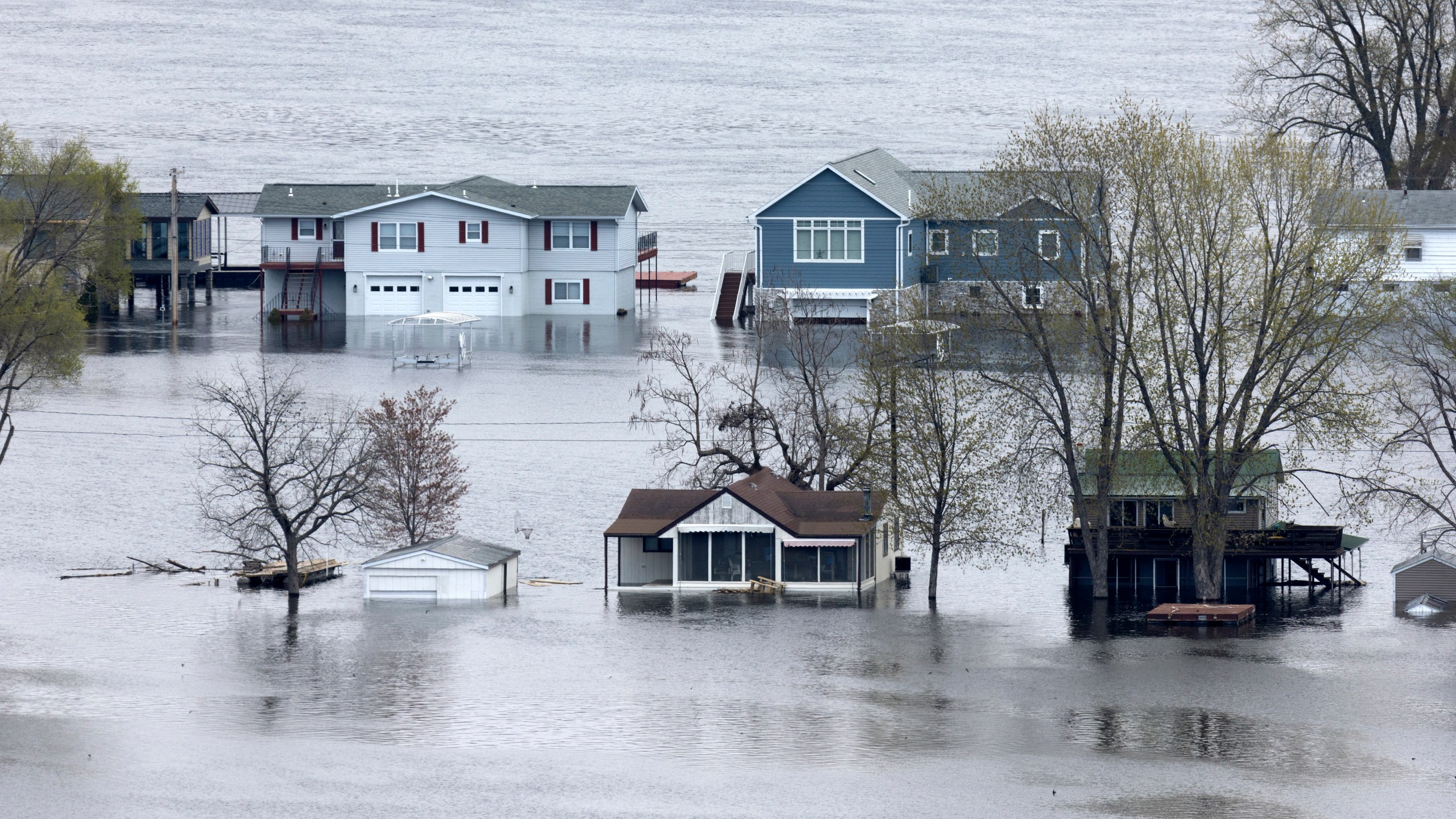 The flooded Mississippi River surrounds the homes on Abel Island near Guttenberg, Iowa, on Tuesday, April 25, 2023. (Stephen Gassman/Telegraph Herald via AP)