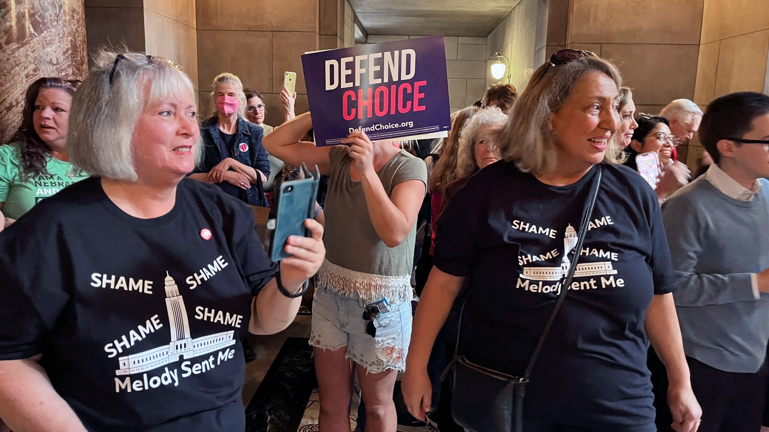 Pat Neal, left, and Ann Fintell, both of Lincoln, celebrate in the Nebraska Capitol rotunda after the failure of a bill that would have banned abortion around the sixth week of pregnancy, Thursday, April 27, 2023 in Lincoln, Neb. The bill is now likely dead for the year, leaving in place a 2010 law that bans abortions at 20 weeks. (AP Photo/Margery Beck)