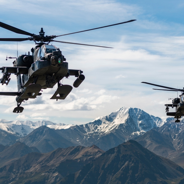 In this photo released by the U.S. Army, AH-64D Apache Longbow attack helicopters from the 1st Attack Battalion, 25th Aviation Regiment, fly over a mountain range near Fort Wainwright, Alaska, on June 3, 2019. The U.S. Army says two Army helicopters similar to the ones in this picture crashed Thursday, April 27, 2023, near Healy, Alaska, killing three soldiers and injuring a fourth. The helicopters were returning from a training flight to Fort Wainwright, based near Fairbanks. (Cameron Roxberry/U.S. Army via AP)